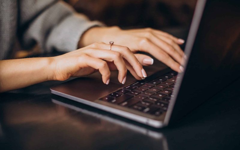 Female hands typing on computer keyboard