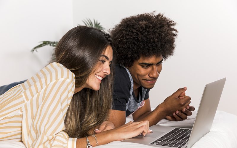 portrait-interracial-couple-using-laptop-together